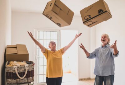 cheerful-senior-people-in-empty-room-playing